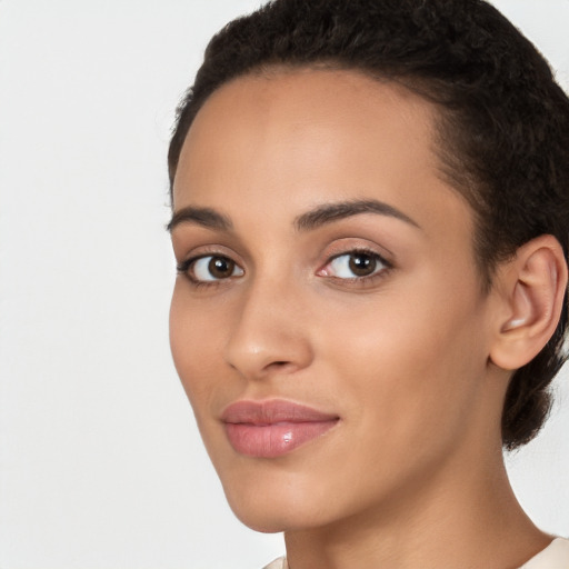 Joyful latino young-adult female with short  brown hair and brown eyes