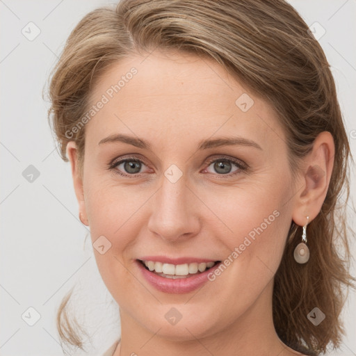 Joyful white young-adult female with medium  brown hair and blue eyes