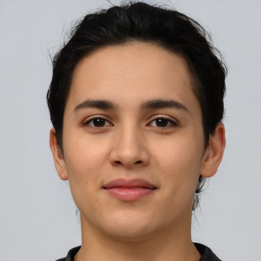 Joyful latino young-adult female with short  black hair and brown eyes