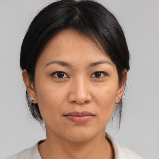 Joyful asian young-adult female with medium  brown hair and brown eyes