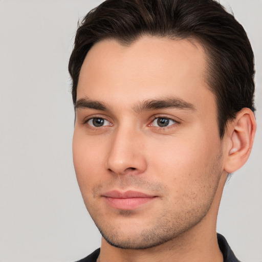 Joyful white young-adult male with short  brown hair and brown eyes