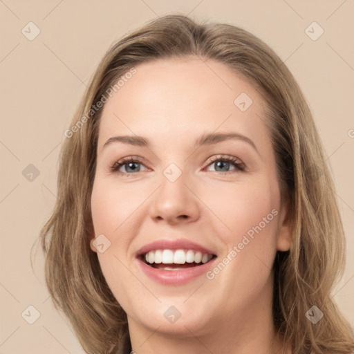 Joyful white young-adult female with long  brown hair and grey eyes