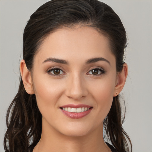 Joyful white young-adult female with long  brown hair and brown eyes