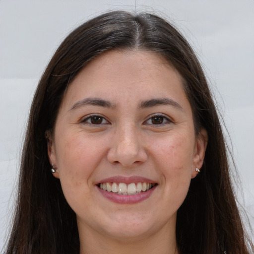 Joyful white young-adult female with long  brown hair and brown eyes