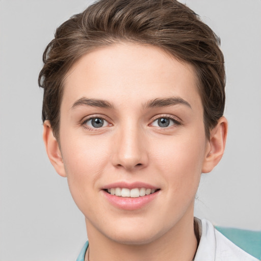 Joyful white young-adult female with short  brown hair and grey eyes