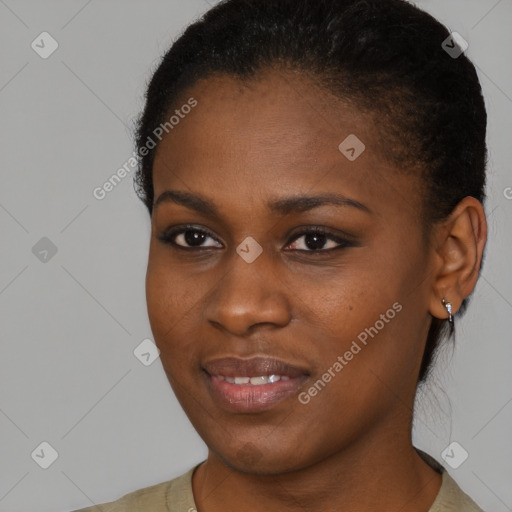 Joyful black young-adult female with short  brown hair and brown eyes