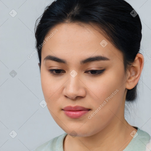 Joyful asian young-adult female with medium  brown hair and brown eyes