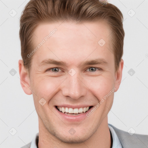 Joyful white young-adult male with short  brown hair and grey eyes