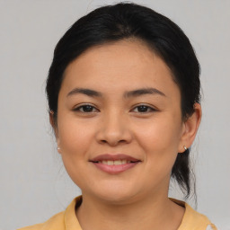 Joyful asian young-adult female with medium  brown hair and brown eyes