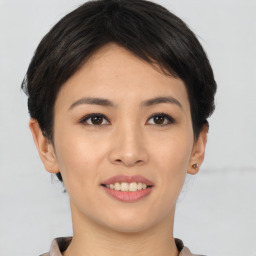 Joyful asian young-adult female with short  brown hair and brown eyes