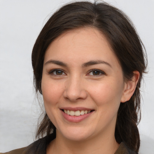 Joyful white young-adult female with long  brown hair and brown eyes