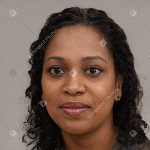 Joyful black young-adult female with long  black hair and brown eyes