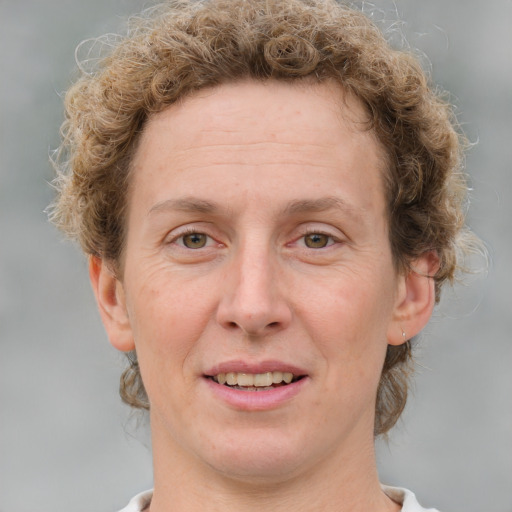 Joyful white adult female with medium  brown hair and blue eyes