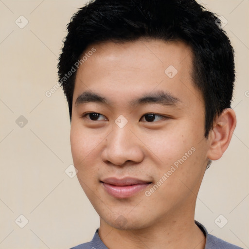 Joyful asian young-adult male with short  black hair and brown eyes