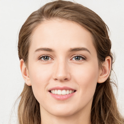 Joyful white young-adult female with long  brown hair and grey eyes