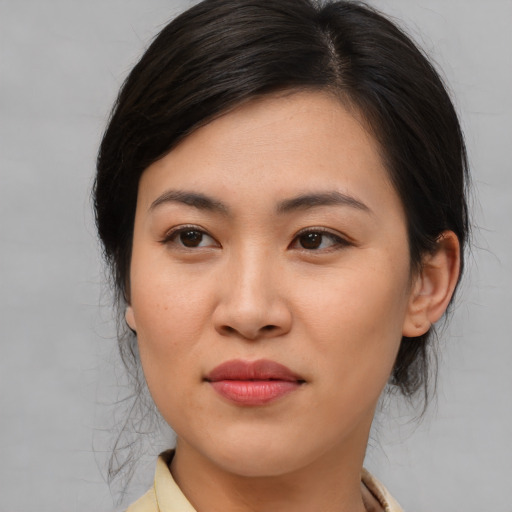 Joyful asian young-adult female with medium  brown hair and brown eyes