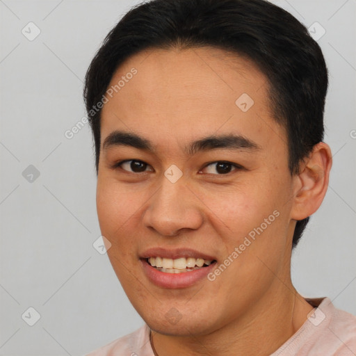 Joyful asian young-adult male with short  brown hair and brown eyes