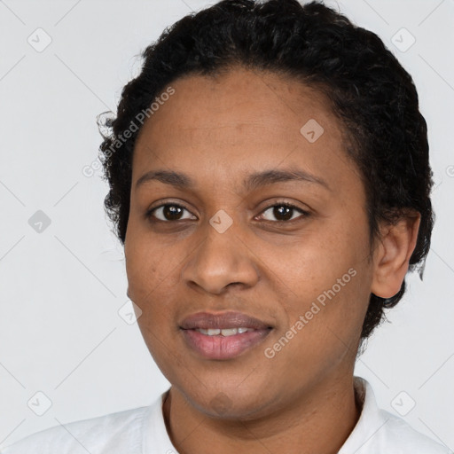 Joyful black young-adult female with short  black hair and brown eyes