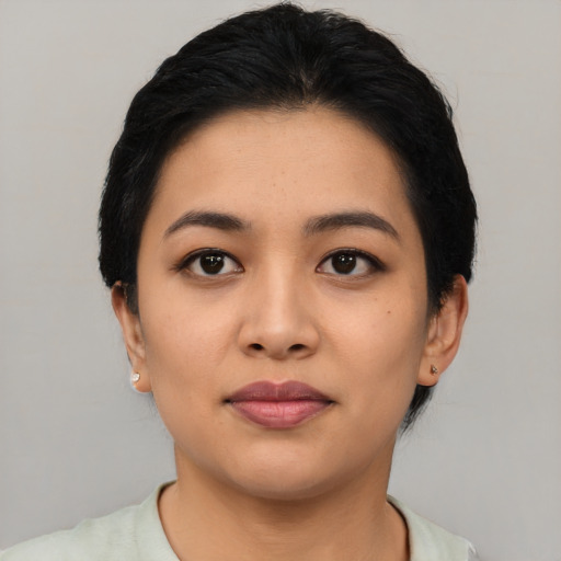 Joyful asian young-adult female with short  black hair and brown eyes