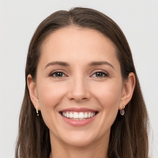 Joyful white young-adult female with long  brown hair and grey eyes