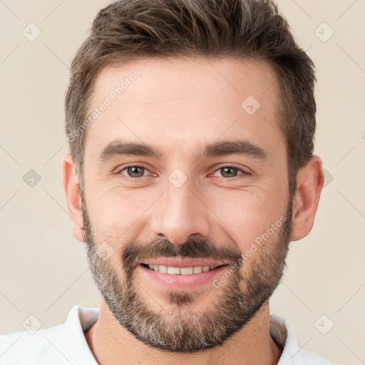 Joyful white young-adult male with short  brown hair and brown eyes