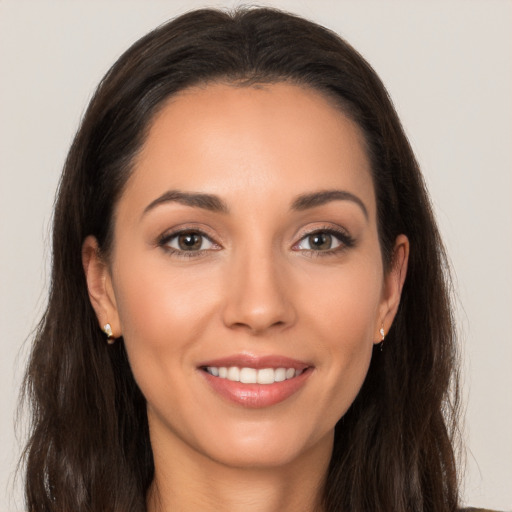 Joyful white young-adult female with long  brown hair and brown eyes