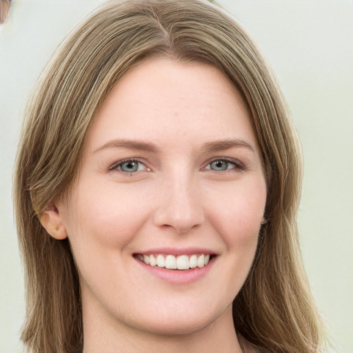 Joyful white young-adult female with long  brown hair and green eyes