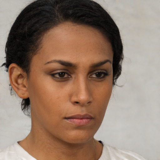 Neutral latino young-adult female with short  brown hair and brown eyes
