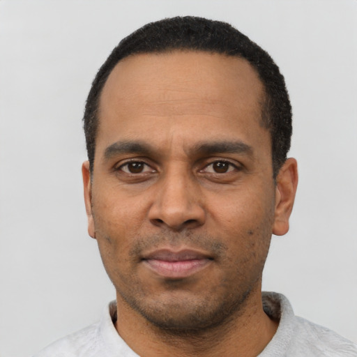 Neutral latino adult male with short  black hair and brown eyes