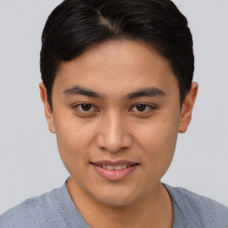 Joyful asian young-adult male with short  brown hair and brown eyes