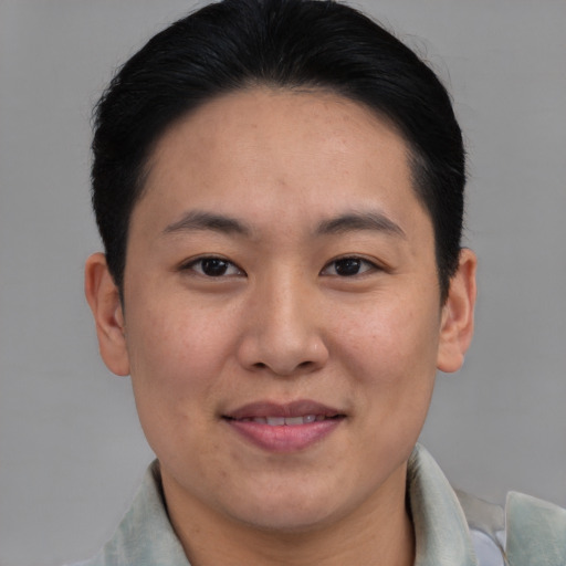 Joyful asian young-adult male with short  brown hair and brown eyes