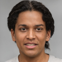 Joyful latino young-adult male with short  brown hair and brown eyes