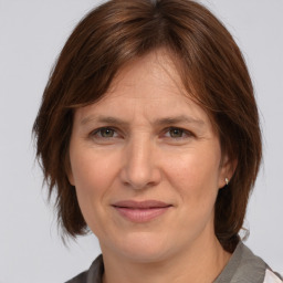 Joyful white adult female with medium  brown hair and grey eyes