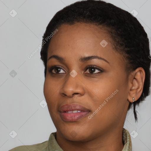 Joyful black young-adult female with short  black hair and brown eyes