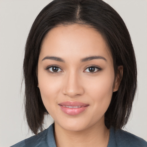 Joyful white young-adult female with medium  black hair and brown eyes