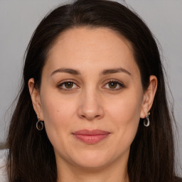 Joyful white adult female with long  brown hair and brown eyes