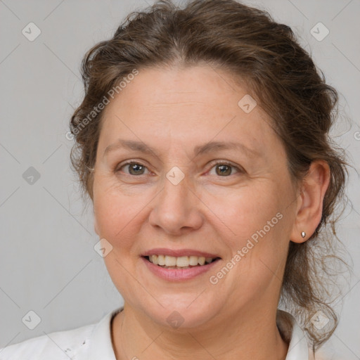 Joyful white adult female with medium  brown hair and brown eyes