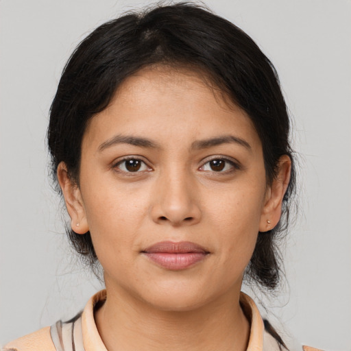 Joyful latino young-adult female with medium  brown hair and brown eyes