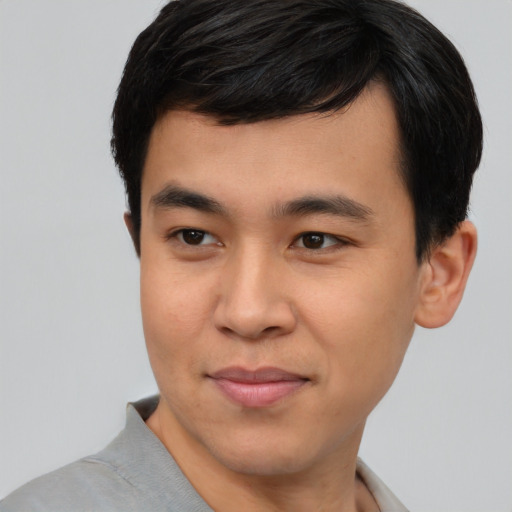 Joyful asian young-adult male with short  brown hair and brown eyes
