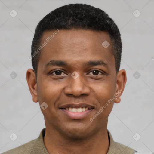 Joyful black young-adult male with short  black hair and brown eyes