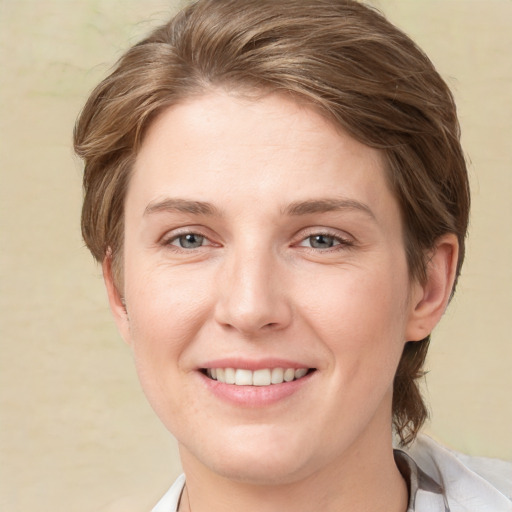 Joyful white young-adult female with medium  brown hair and grey eyes