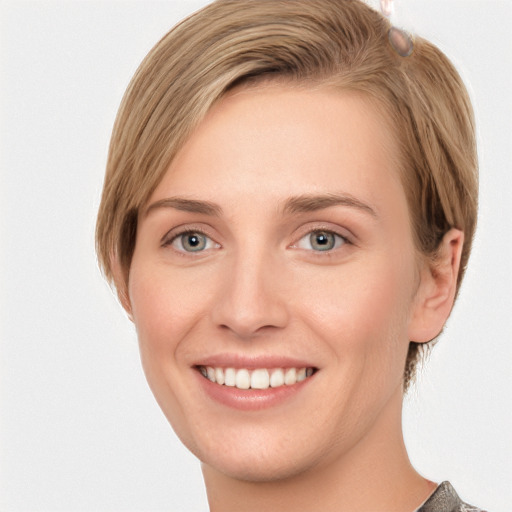 Joyful white young-adult female with short  brown hair and grey eyes