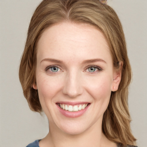 Joyful white young-adult female with long  brown hair and blue eyes