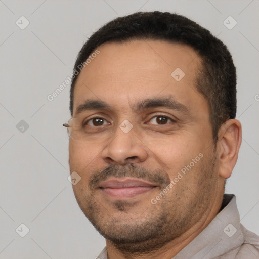 Joyful white adult male with short  black hair and brown eyes