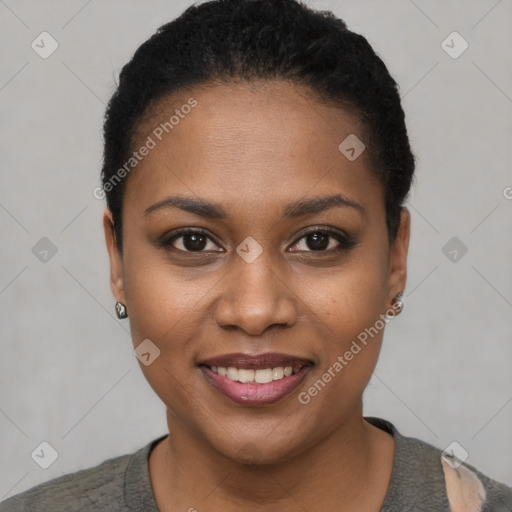 Joyful black young-adult female with short  black hair and brown eyes