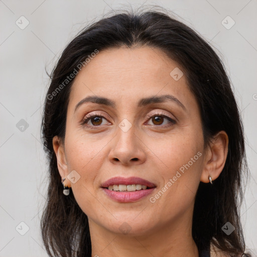 Joyful white adult female with long  brown hair and brown eyes