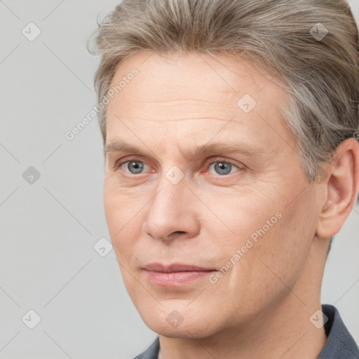 Joyful white adult male with short  brown hair and grey eyes