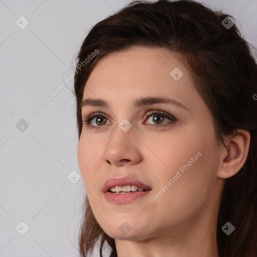 Joyful white young-adult female with long  brown hair and brown eyes