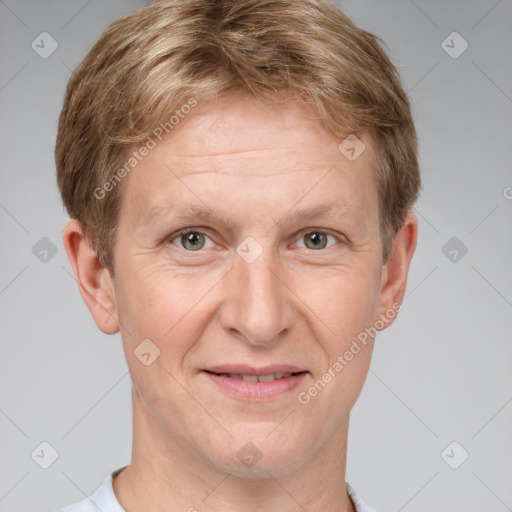 Joyful white adult male with short  brown hair and grey eyes