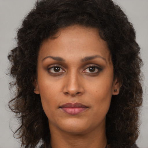 Neutral black young-adult female with long  brown hair and brown eyes